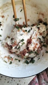 Chopped scallions added to the risen wet dough with marinated pork