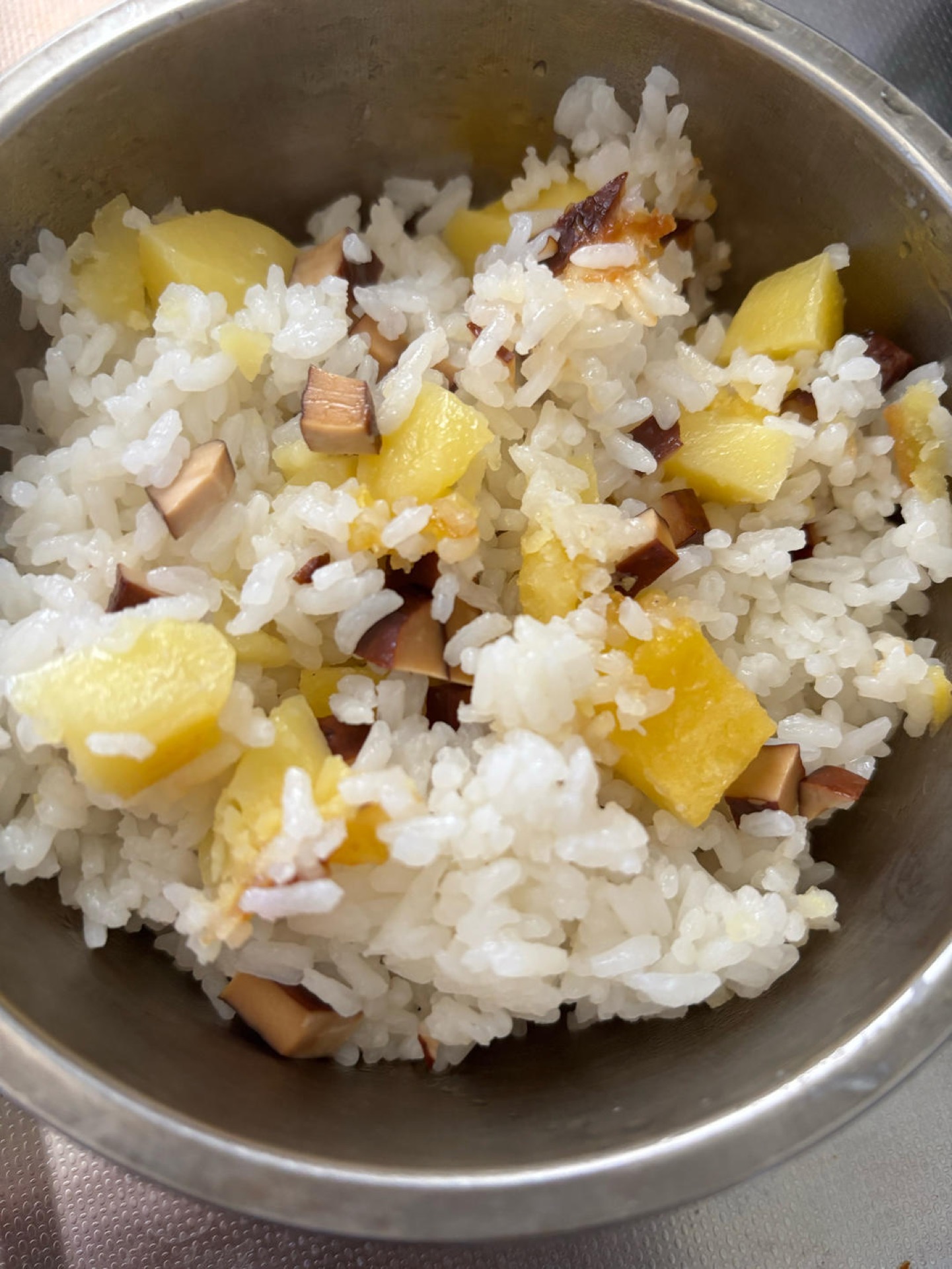Old-style rice cooker potato rice in an open pot showing golden potato chunks, diced smoked tofu, and fluffy jasmine rice