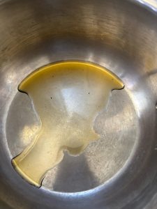 Pour the mushroom oil into the rice cooker pot and swirl it around so the base is evenly coated.