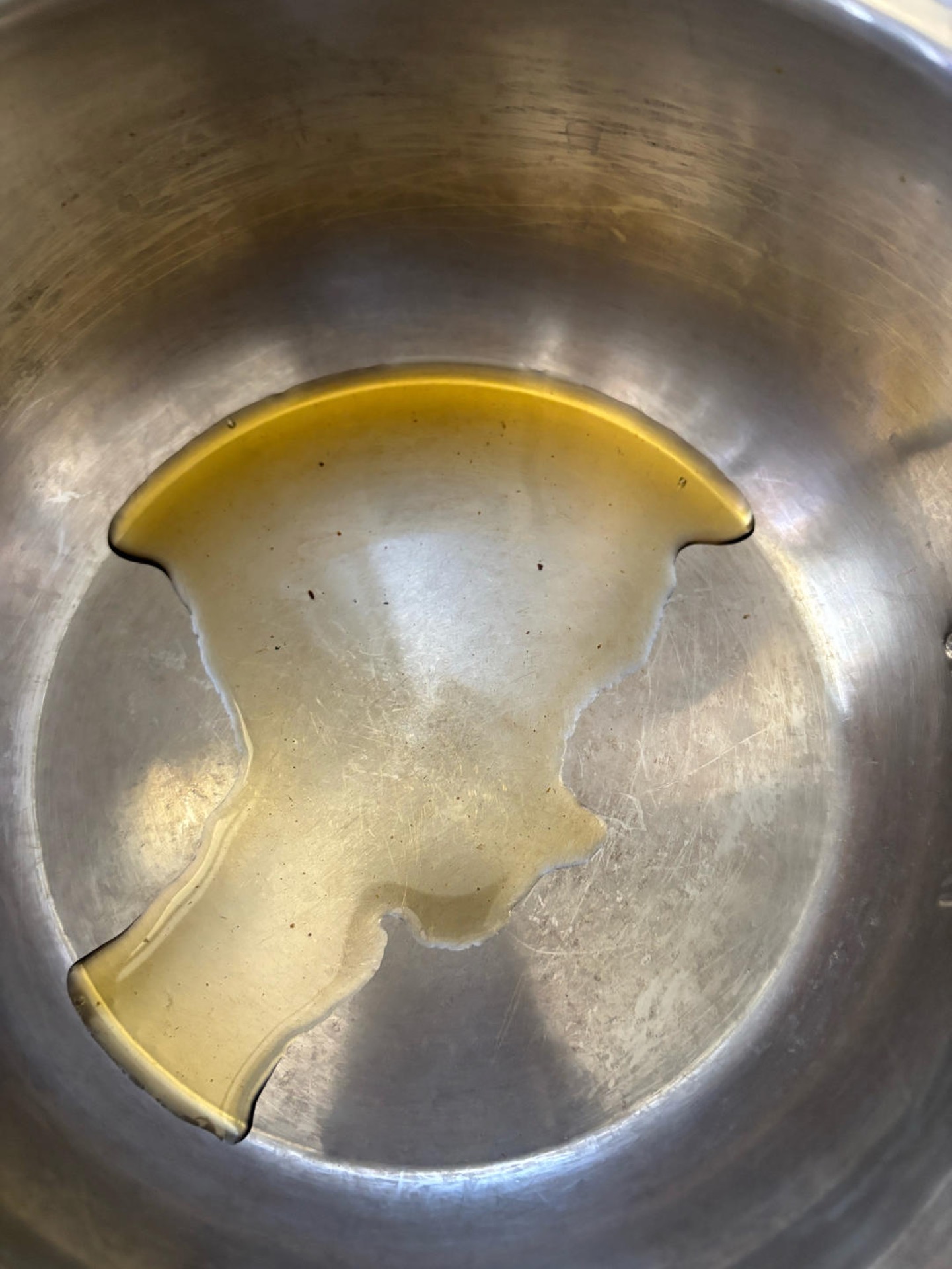 Pour the mushroom oil into the rice cooker pot and swirl it around so the base is evenly coated.