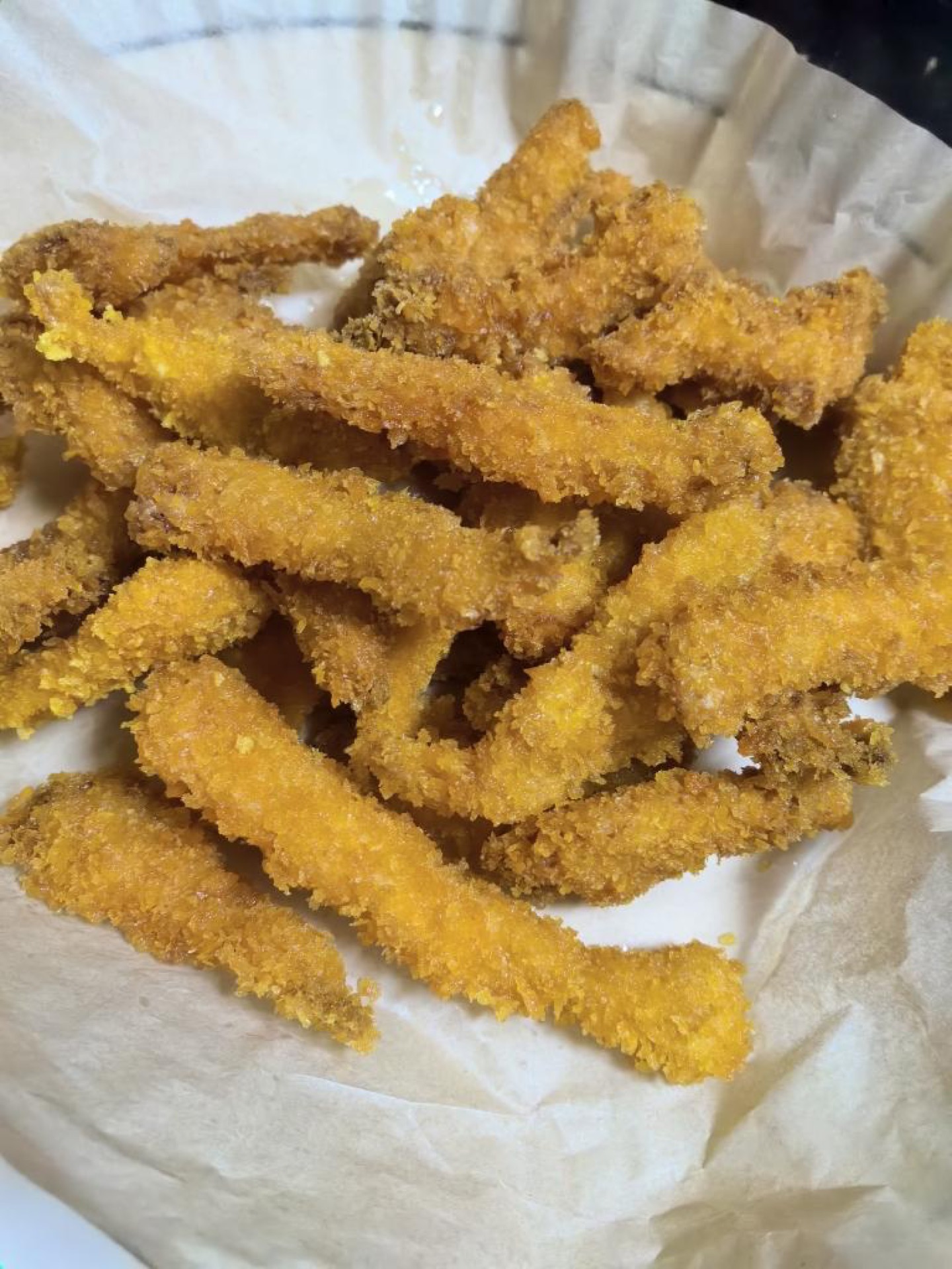 Remove the strips with a slotted spoon and drain — the chicken tenders are ready.
