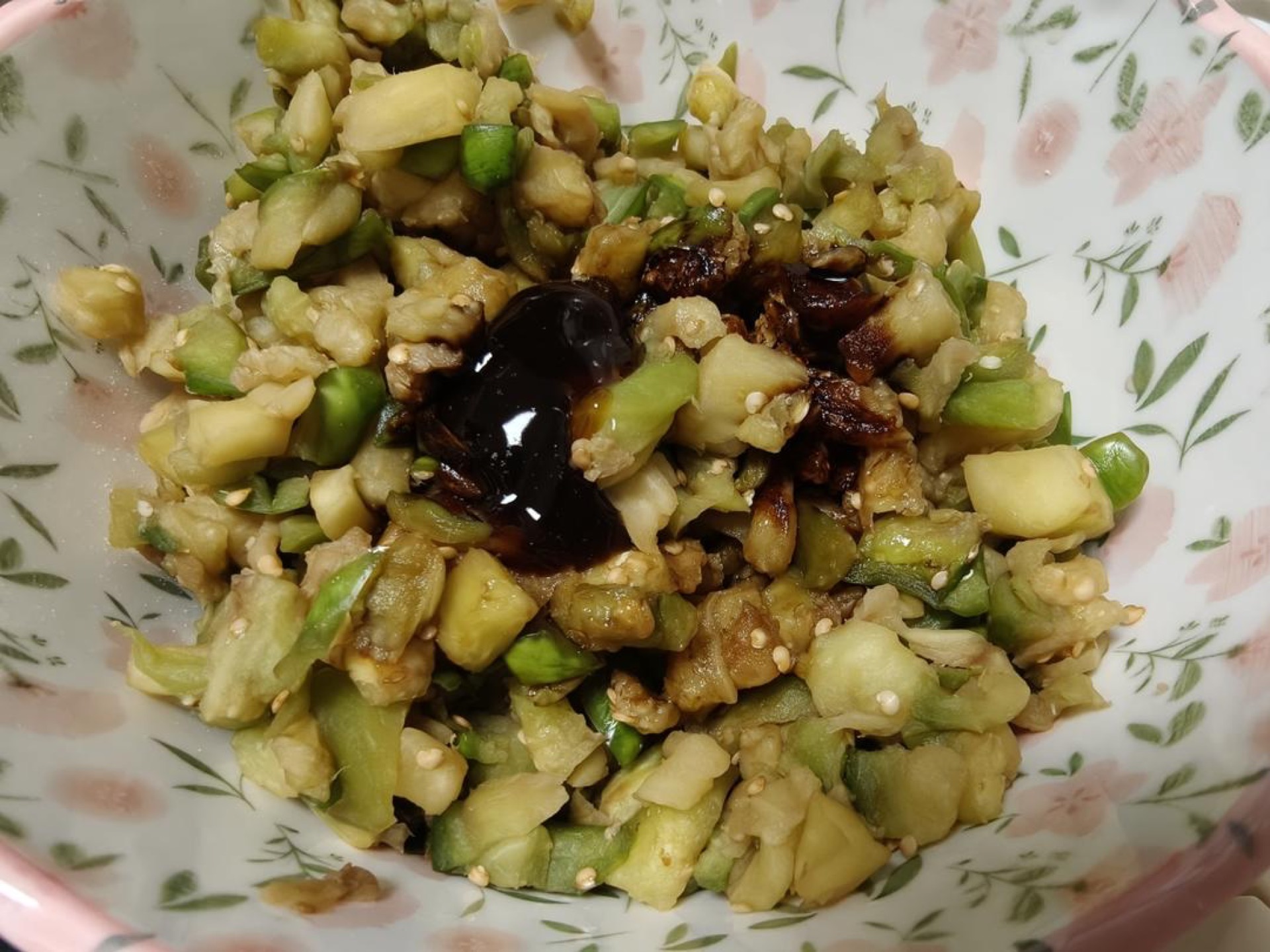 Wash the eggplant clean — a young eggplant does not need peeling (an older one can be peeled). First cut it into slices, then into strips, and finally into small dice, put them in