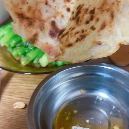 Flaky layered Chinese flatbread on a griddle