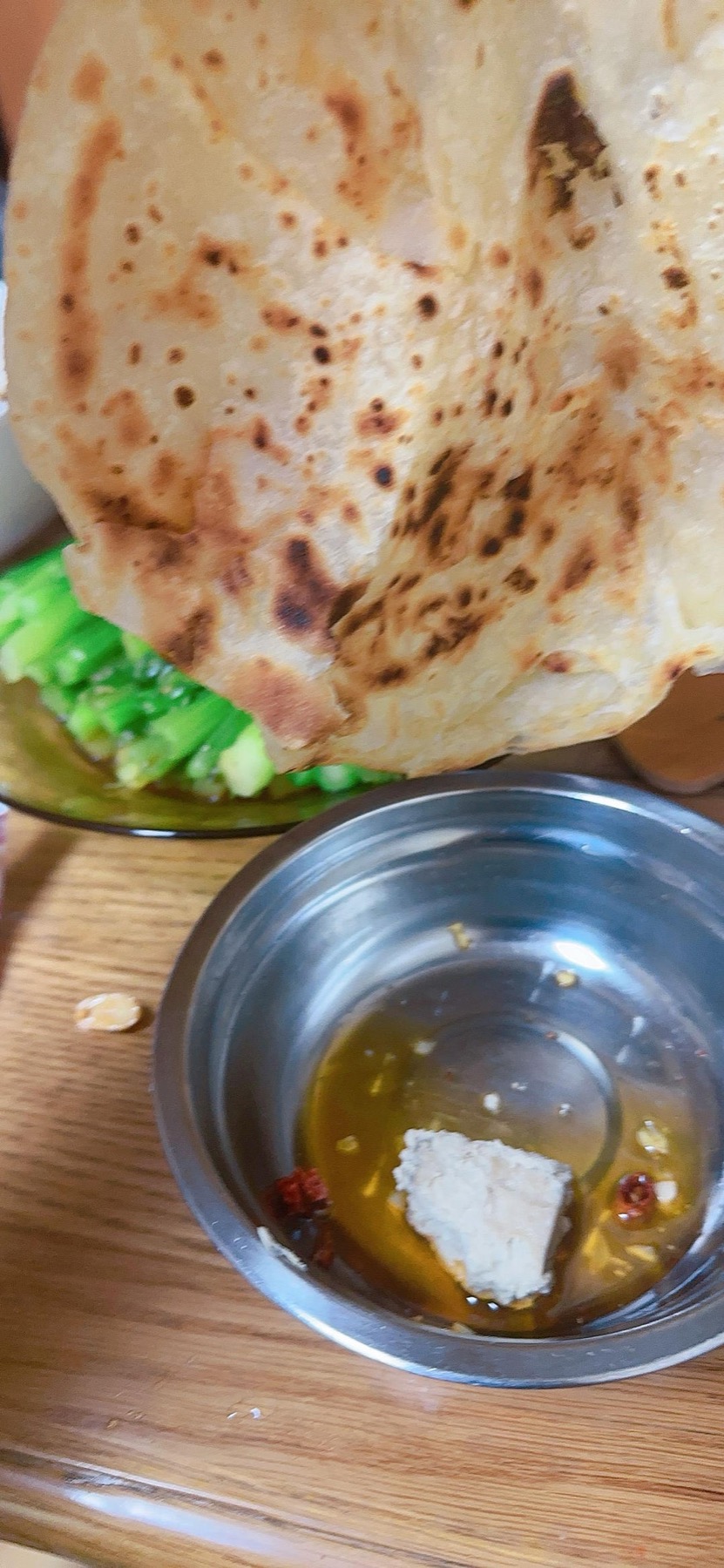 Flaky layered Chinese flatbread on a griddle
