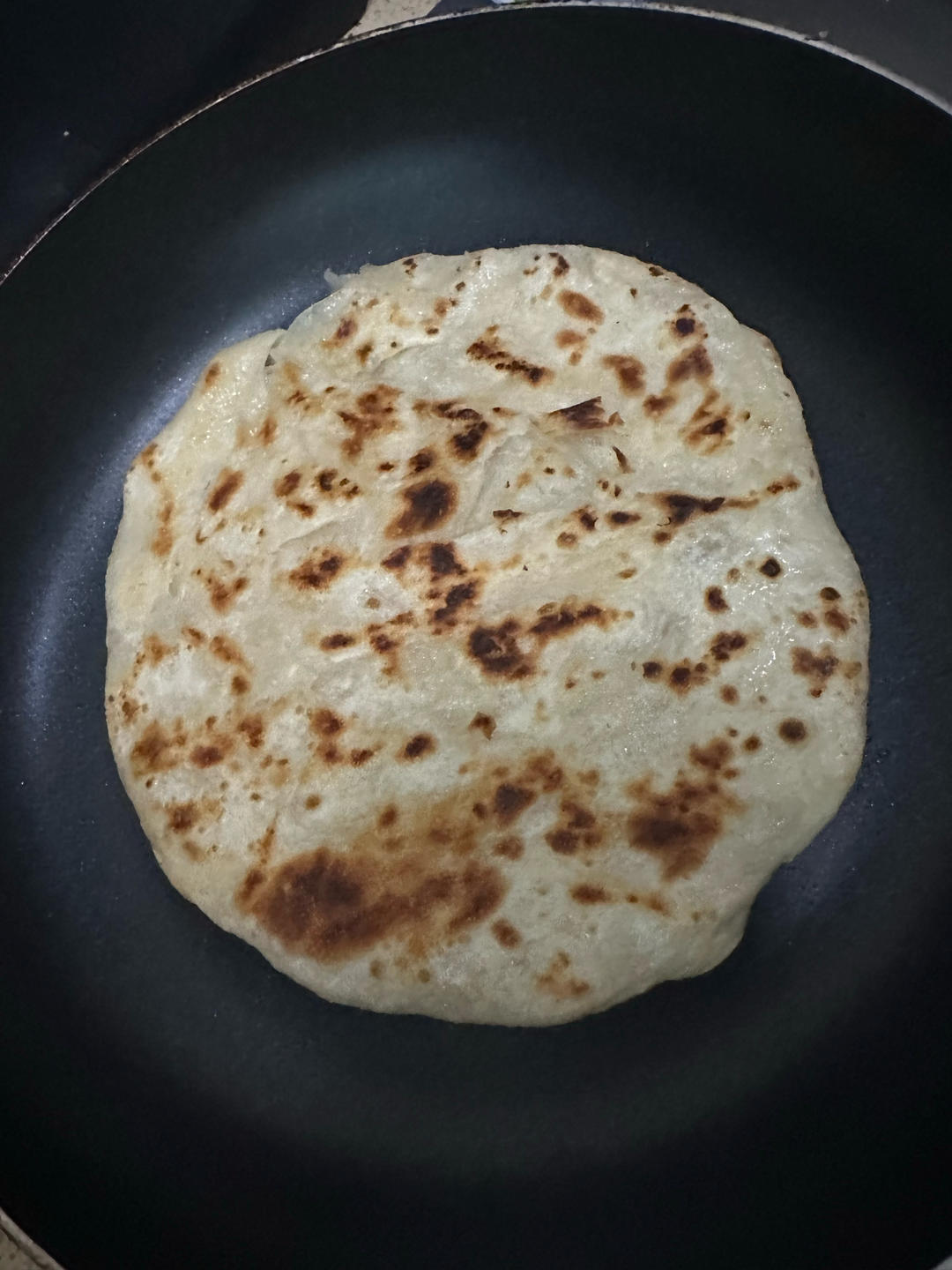Flatbread flipped and frying until golden