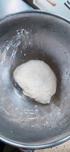 Dough resting in a covered bowl in the fridge