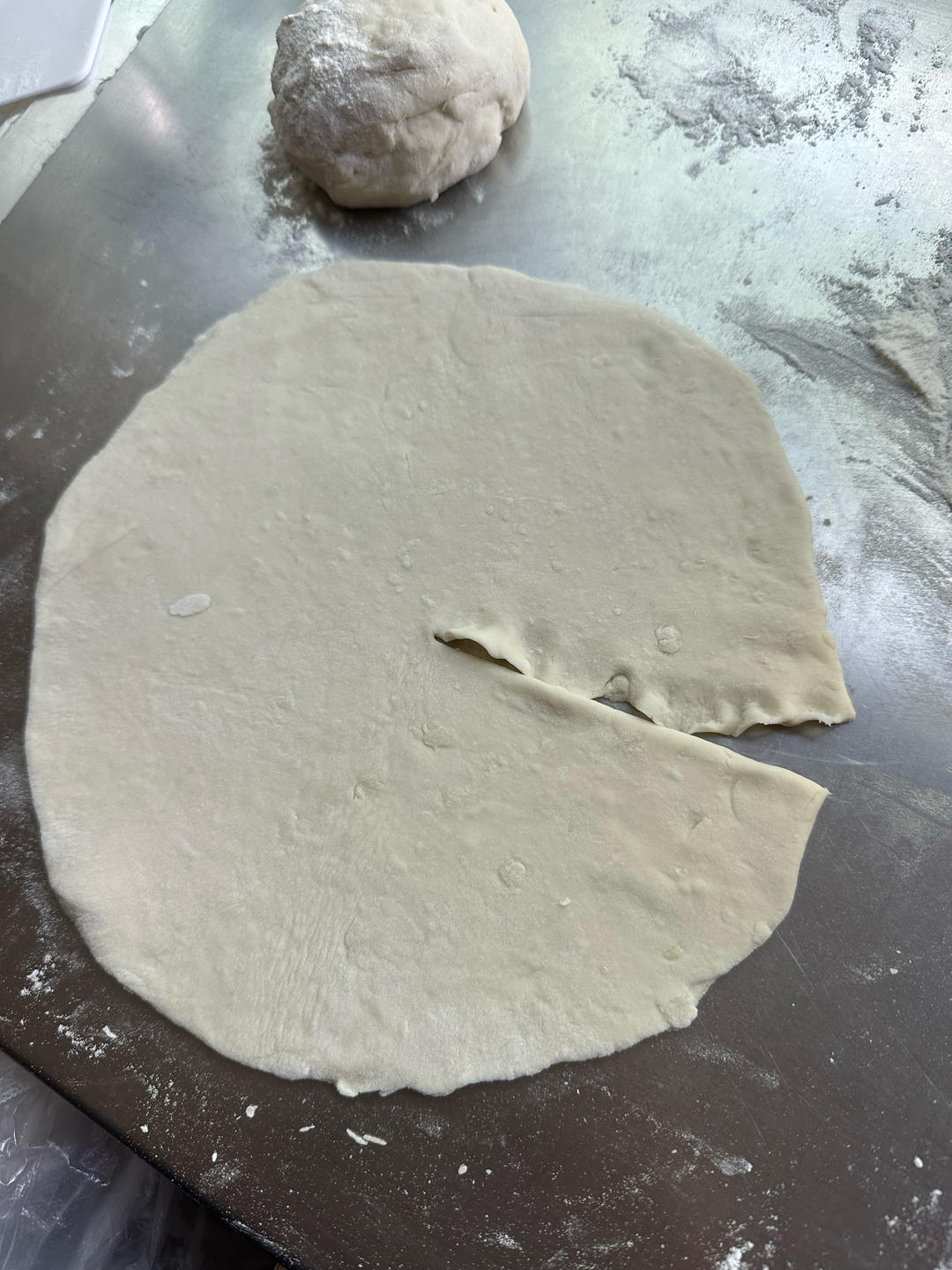 Dough being kneaded on a floured surface