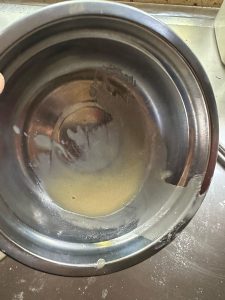 Hot oil being poured over flour to make the oil-roux