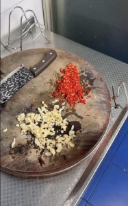 Chopping garlic and chilies for the dish