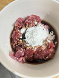 Slice the fresh beef thinly against the grain and add 2 tablespoons Shaoxing wine, 3 tablespoons light soy sauce, 1 tablespoon oyster sauce, 2 tablespoons cornstarch, and 1 tablesp