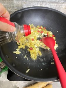 Splash in a little light soy sauce and stir to combine so the aromatics pick up color and salt.