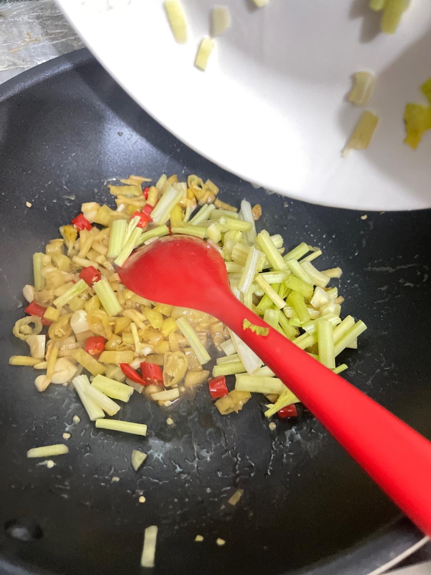 Add the celery stems and stir-fry for about 1 minute, just until they turn bright green and slightly tender.
