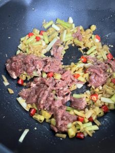 Add the marinated beef and stir-fry over high heat, spreading it out so every slice makes contact with the hot wok.