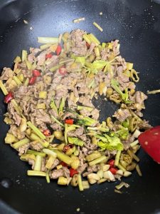 Stir-fry until the beef just turns color, then add the remaining celery leaves and cook for another 30 seconds.
