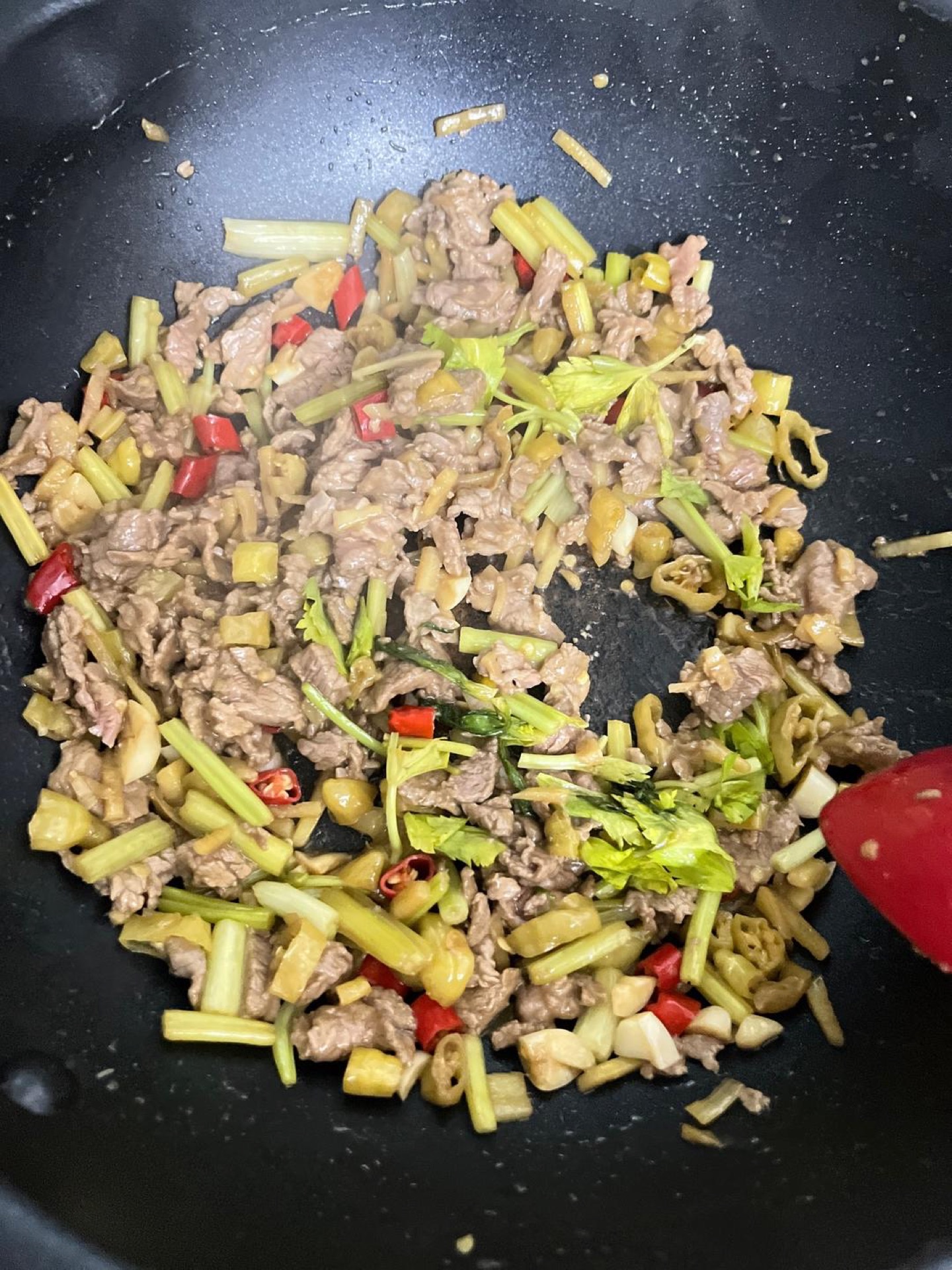 Stir-fry until the beef just turns color, then add the remaining celery leaves and cook for another 30 seconds.