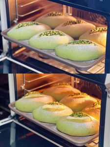 Bread baking in the oven on a lined tray