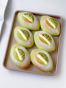 Freshly baked pistachio cream cheese bread on a cooling rack