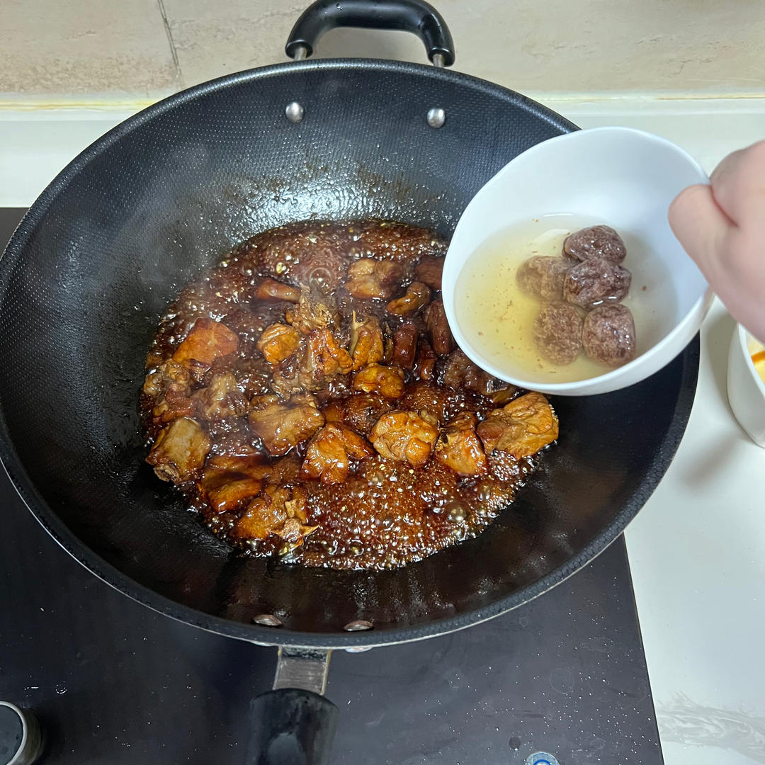 Add the dried plums (hua mei), soaked in warm