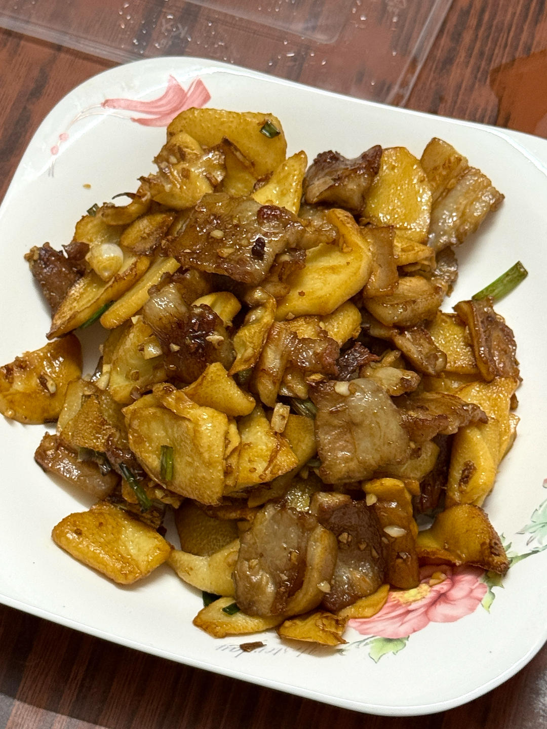 Pork belly and bamboo shoots stir-fried in a wok