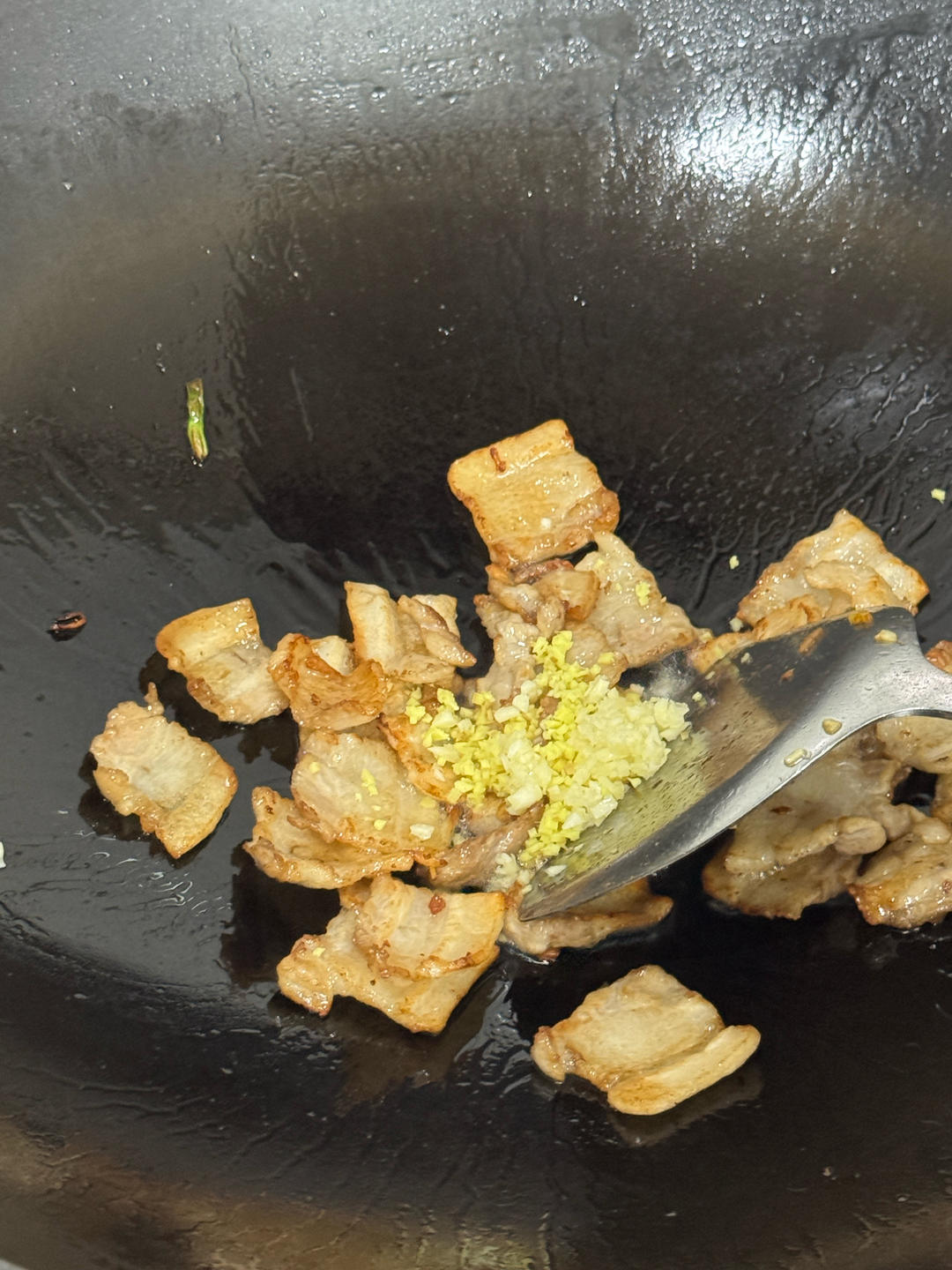 Ginger and garlic added to the rendered pork
