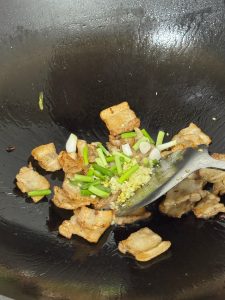 Scallion added to the wok