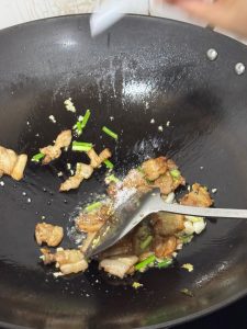 A pinch of salt being added to the pork