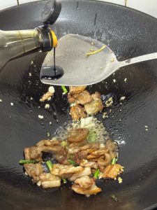 Dark soy sauce being added for color