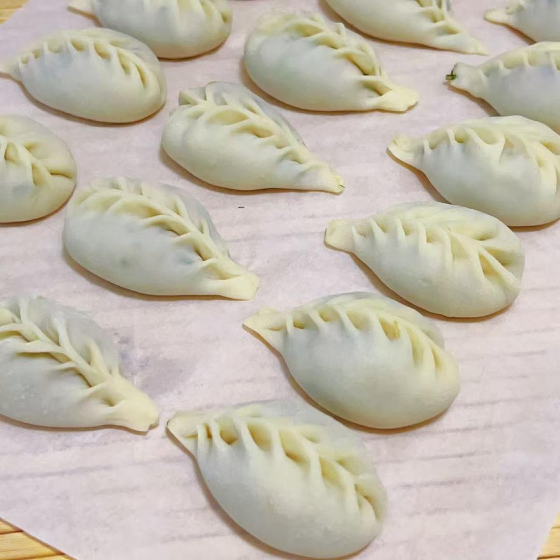 Pork shrimp fennel dumplings arranged on a plate, freshly steamed and ready to serve