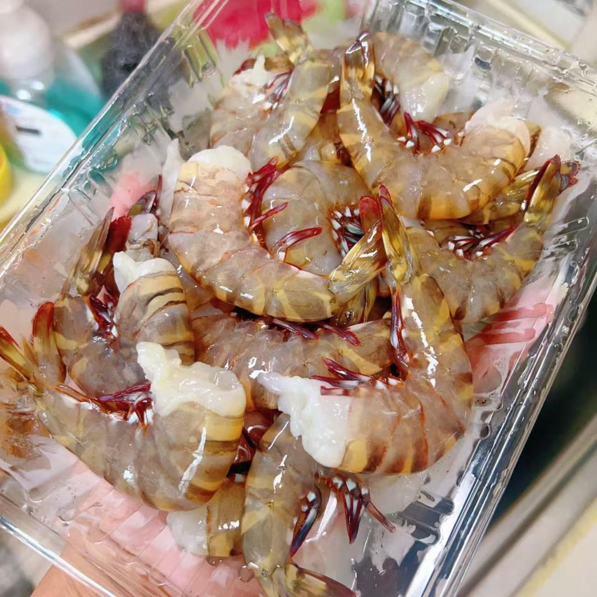 Twist the head off each red-leg shrimp and pull gently so the head and the digestive tract come away together.