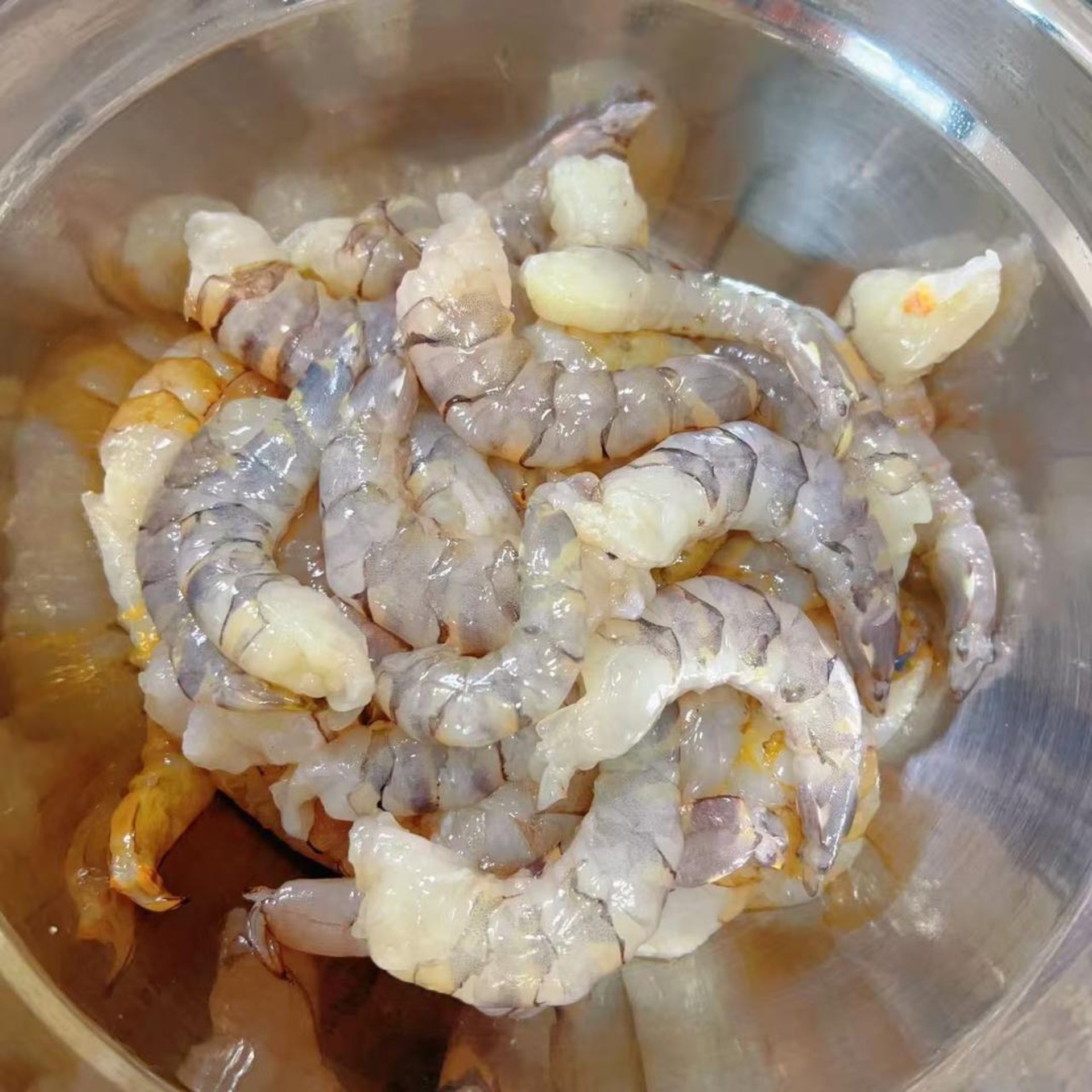 Remove the shells from the remaining shrimp tails.
