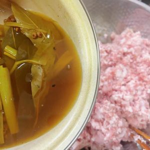 Once cool, add the water to the meat in small additions, stirring clockwise after each one, until the filling is sticky, moist, and no longer dry or weeping liquid.
