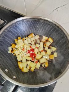 Garlic and chilies blooming in oil with soy sauce