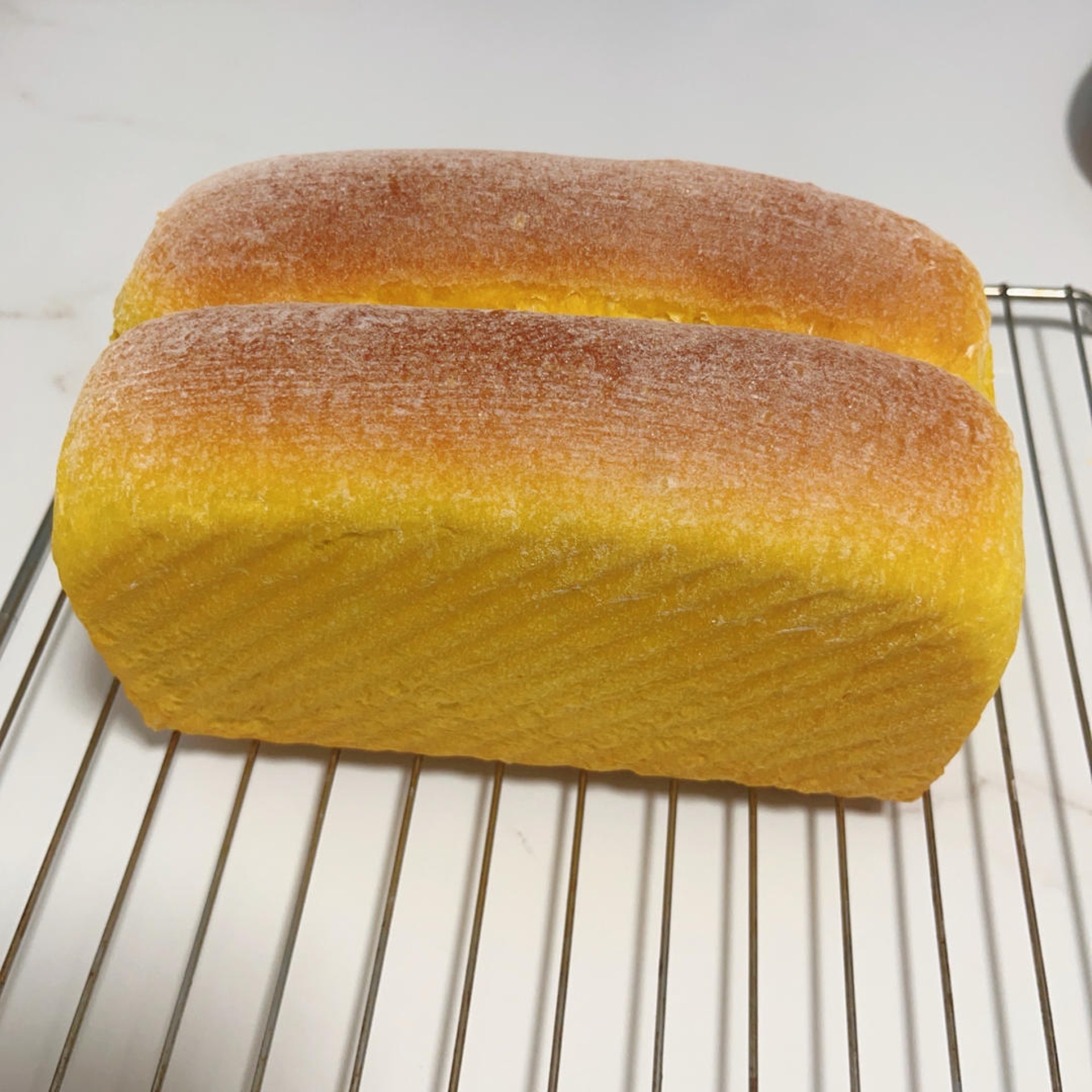 Sliced pumpkin cheese toast showing a golden cream cheese swirl