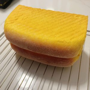 Pumpkin cheese toast cooling on its side on a wire rack