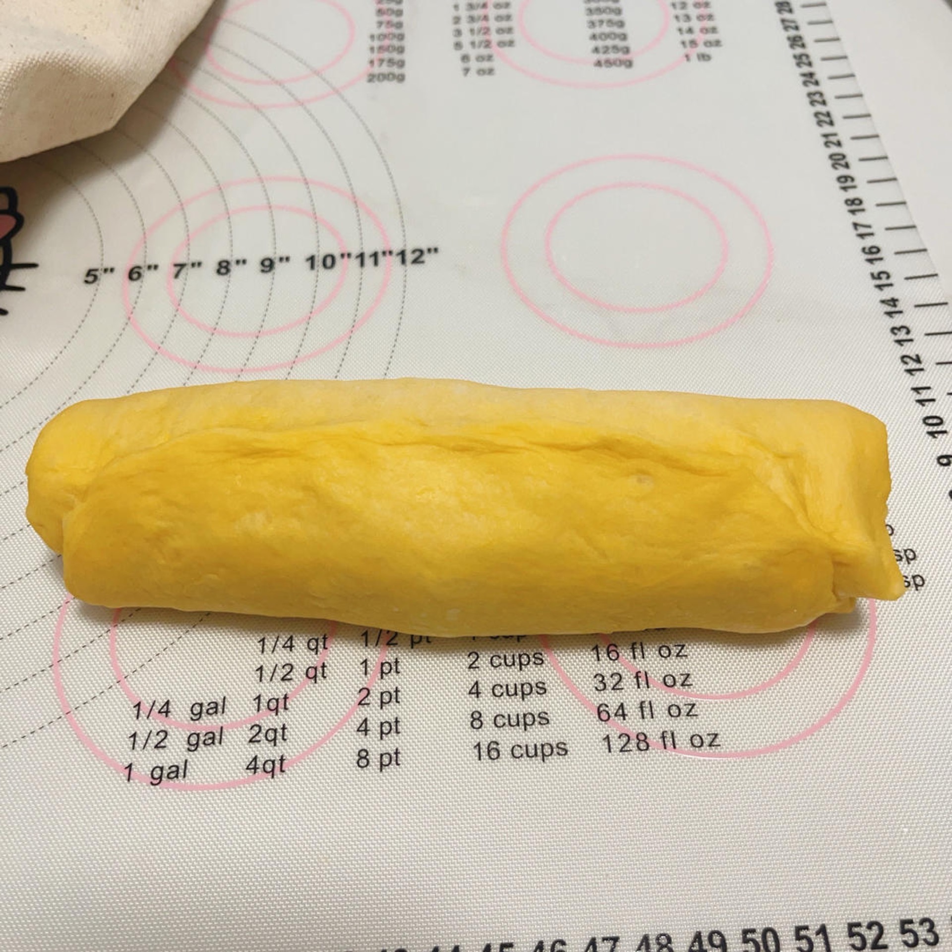 Rolled pumpkin dough log with cream cheese swirl