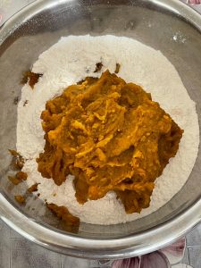 Adding yeast and baking powder to the flour with the pumpkin purée