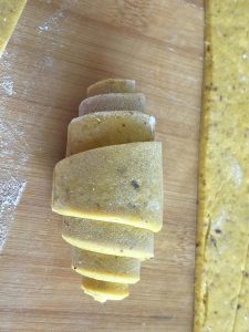 Shaped pumpkin buns arranged on steamer paper