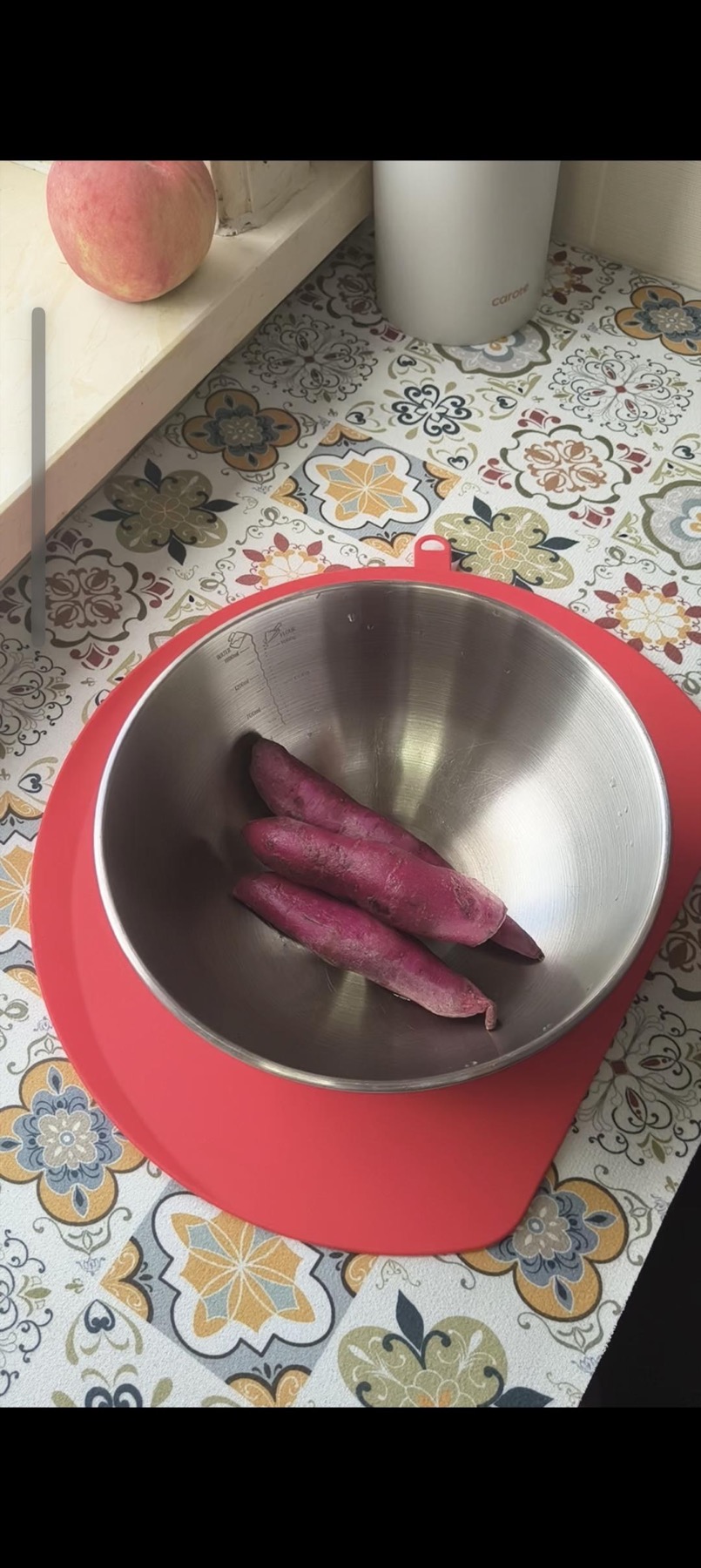 Purple sweet potatoes peeled on a cutting board