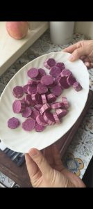 Sliced purple sweet potato steaming in the steamer