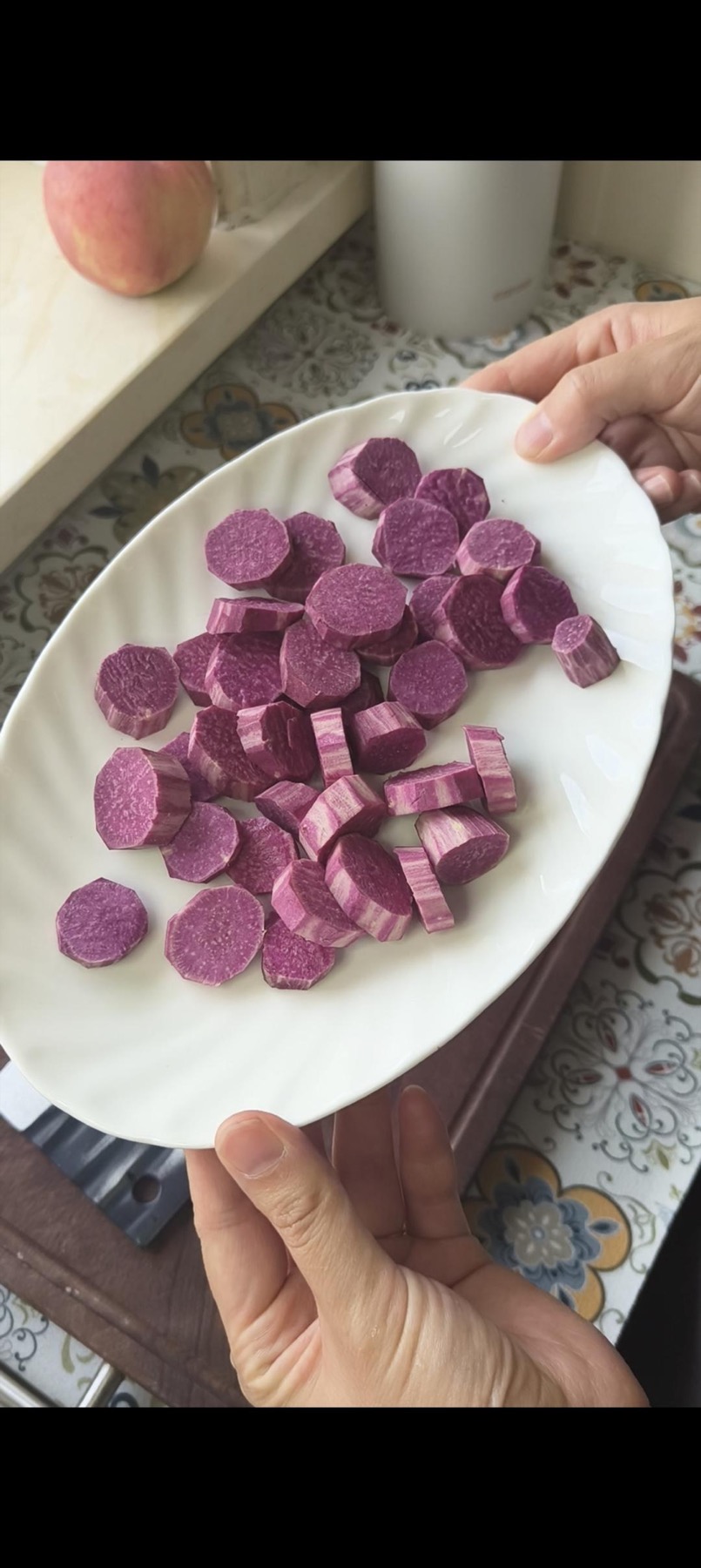 Sliced purple sweet potato steaming in the steamer
