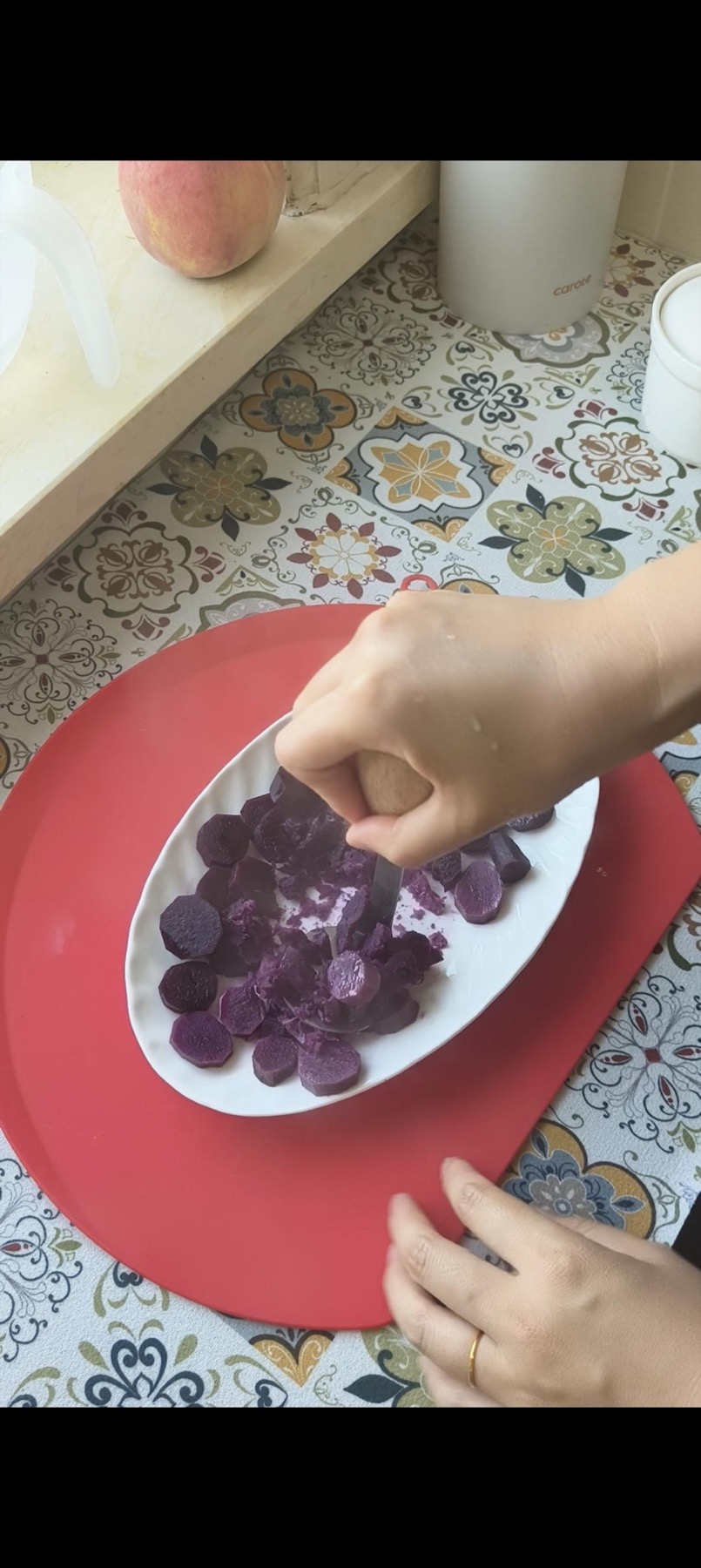Hot purple sweet potato being mashed
