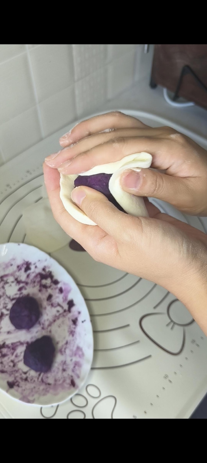 Purple sweet potato being wrapped in the dough