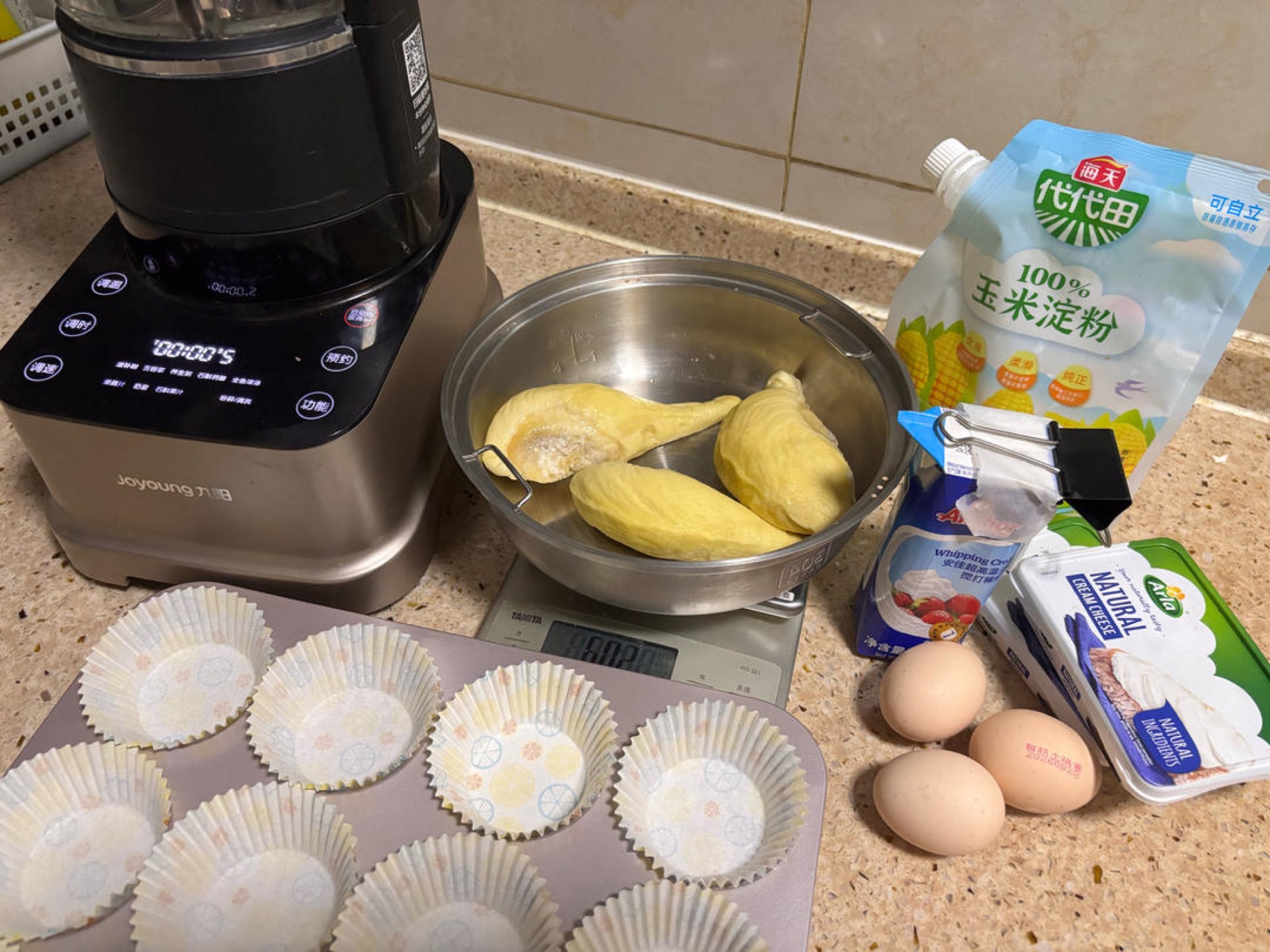 Ingredients for durian Basque cheesecake cups laid out on a counter