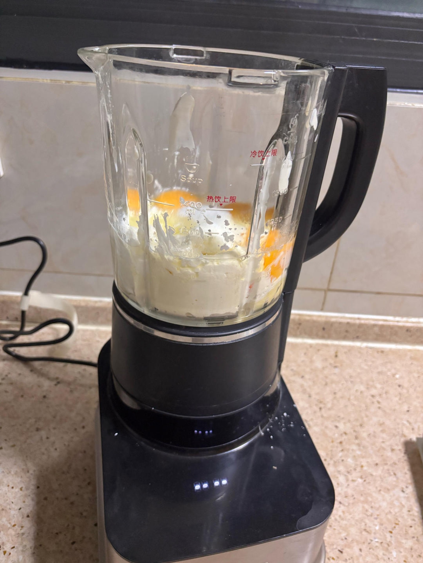 Blended durian cheesecake batter in a blender pitcher