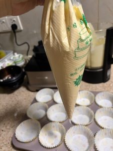 Batter poured into a piping bag for filling cups