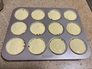 Paper cups filled with durian cheesecake batter