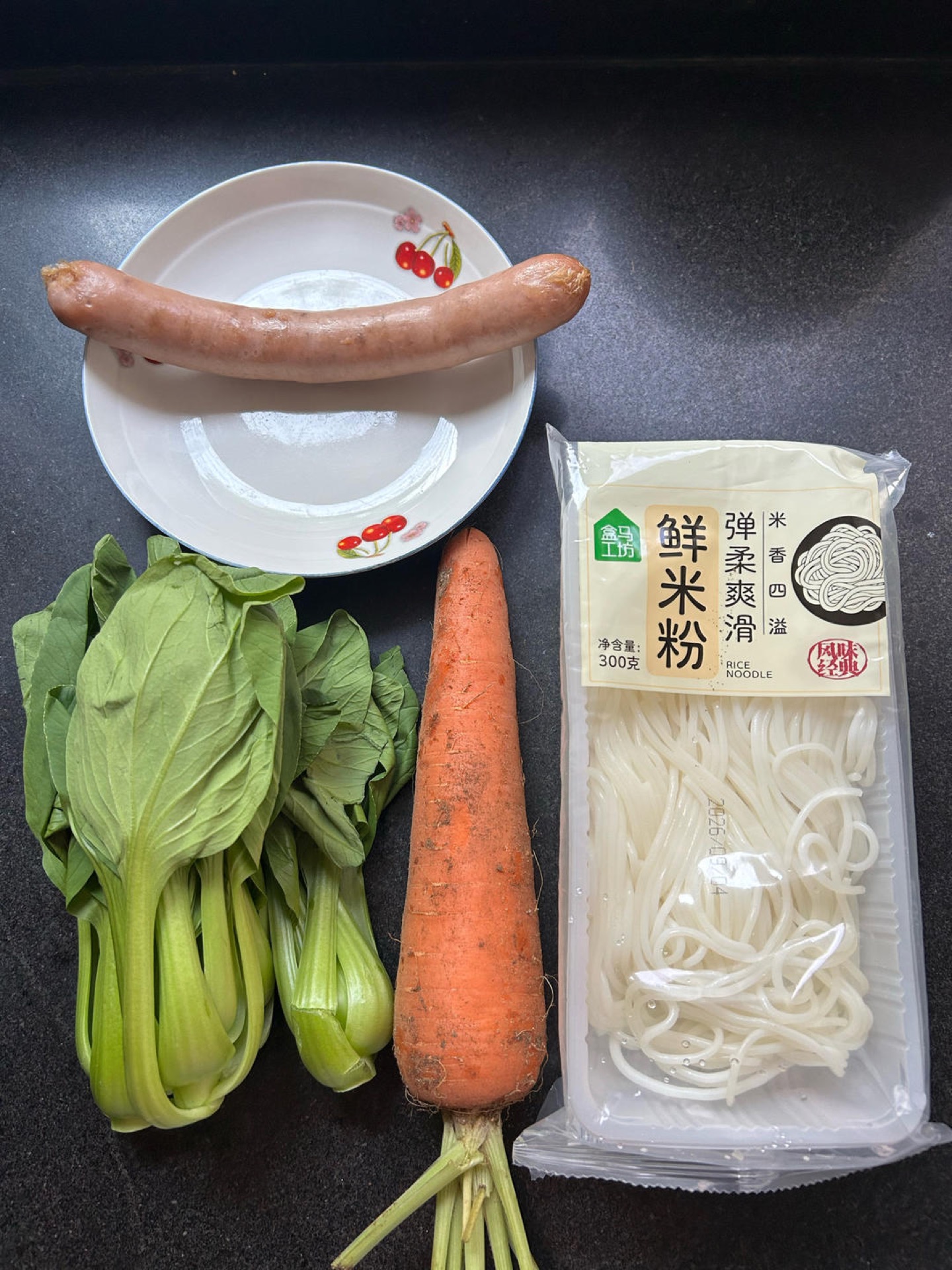 All ingredients for quick stir-fried fresh rice noodles laid out on a counter