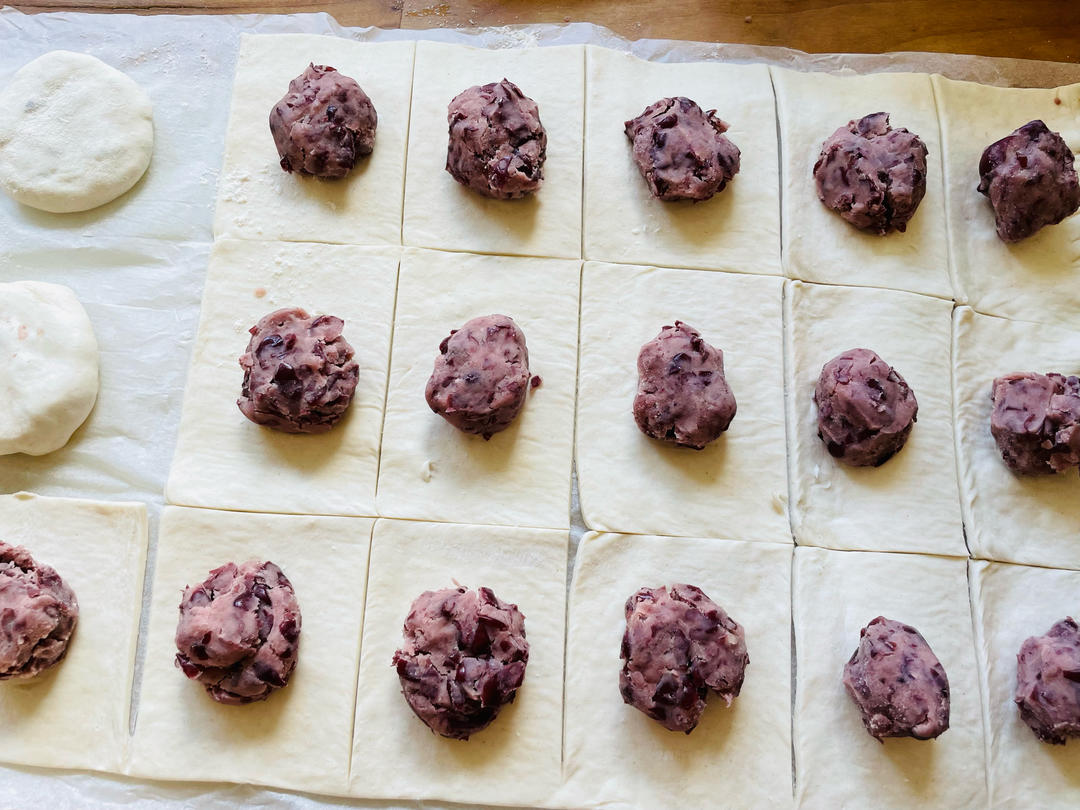 Spoonfuls of red bean paste placed on puff pastry squares