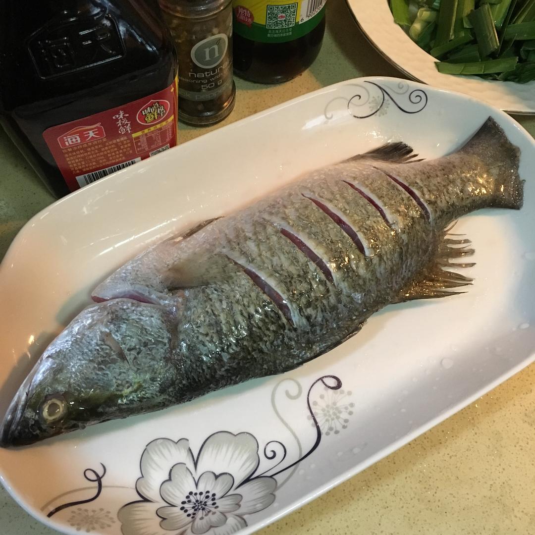 Score the fish with a knife pattern and rub b
