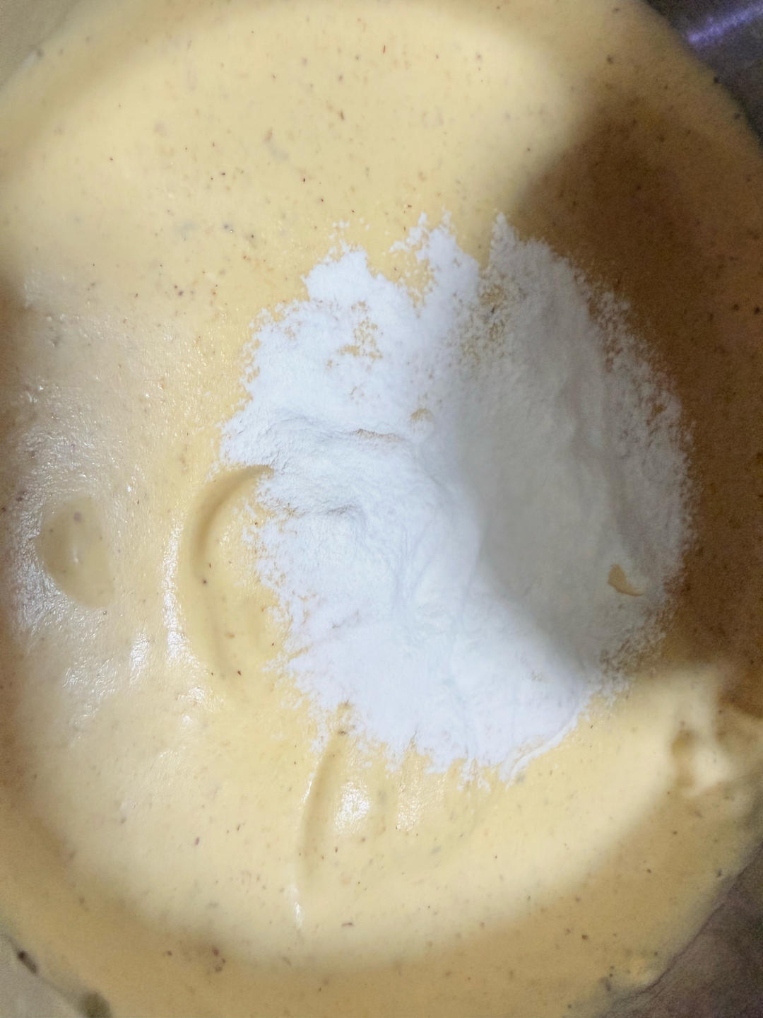 Folding sifted flour into the whipped batter